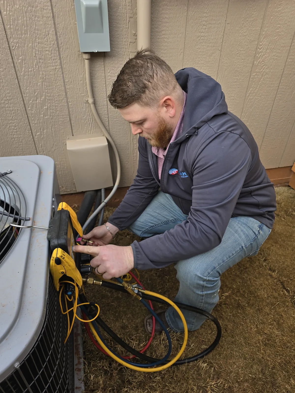 Tytan technician connecting gauges to an outdoor unit