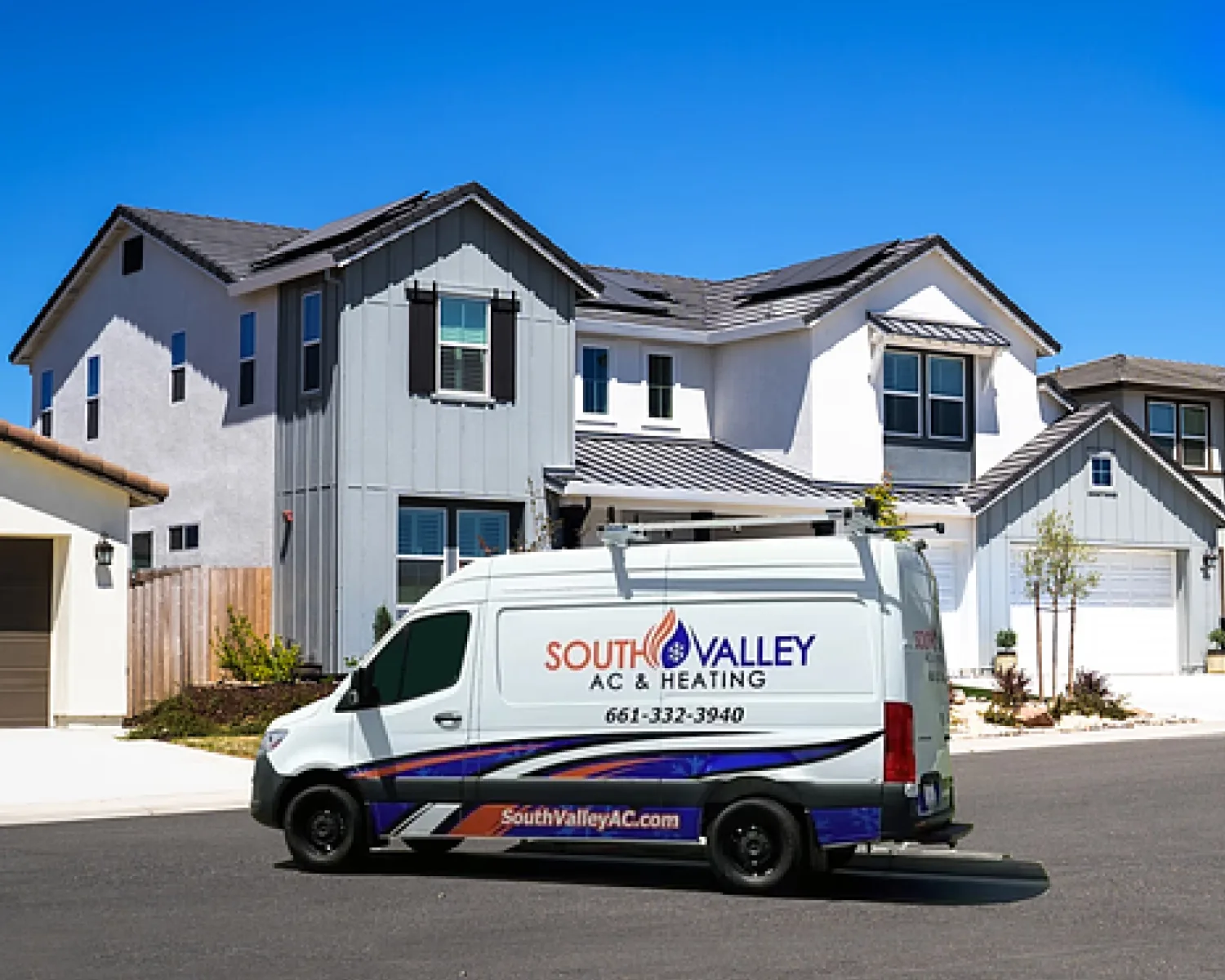 South Valley AC & Heating service van in a residential street