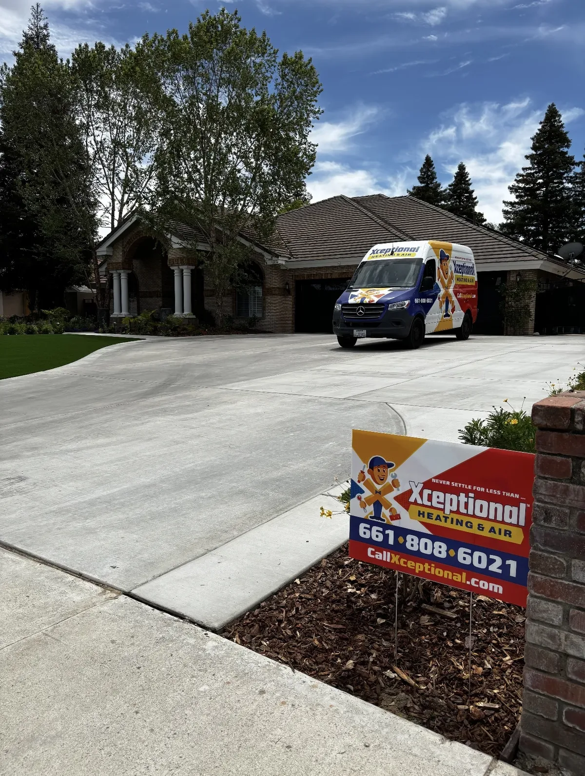 Xceptional Heating & Air van and yard sign at a job