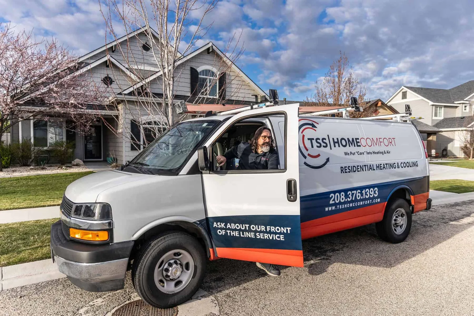 TSS Home Comfort technician stepping out of a company van