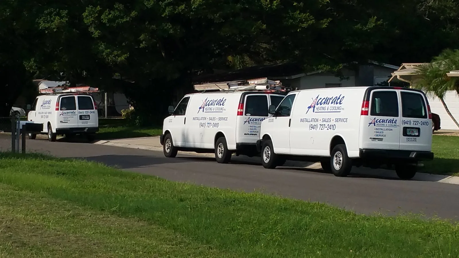 Accurate Heating & Cooling service vans parked in a row
