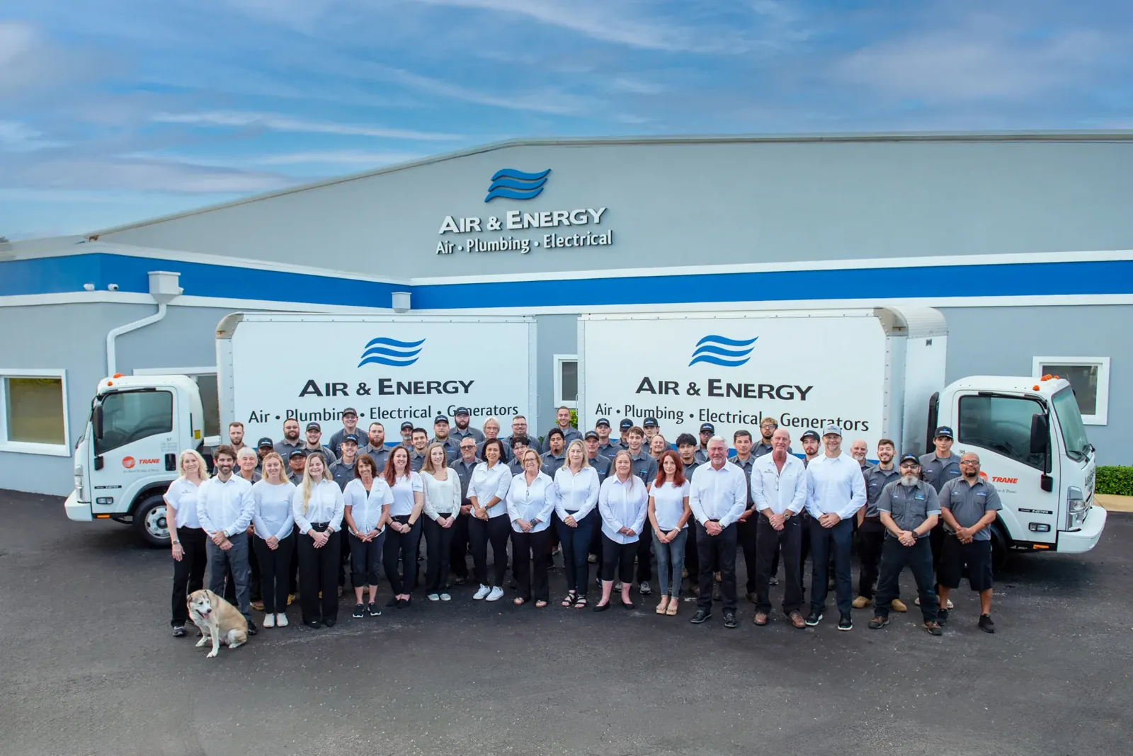 Air & Energy staff in front of the company building and box trucks