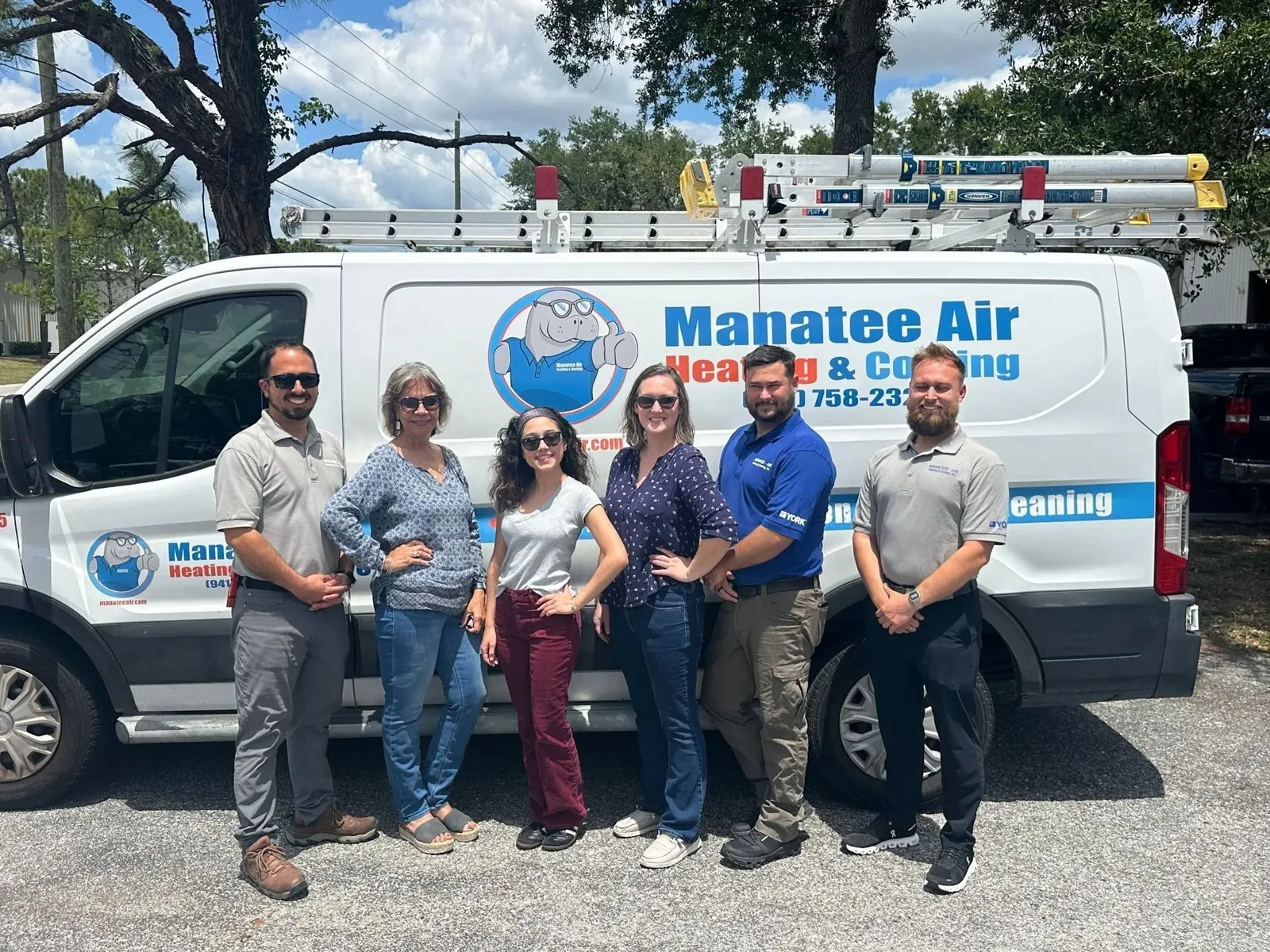 Manatee Air team in front of a lettered service van
