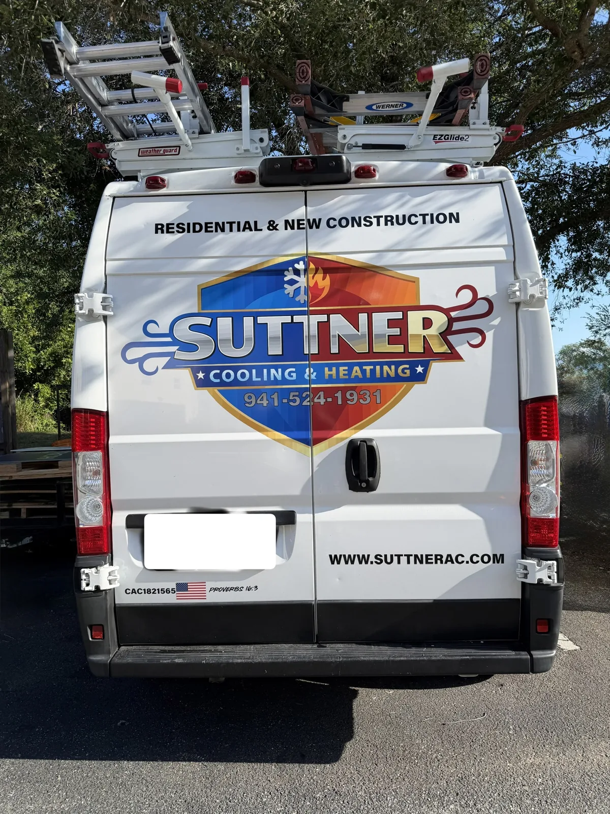 Rear of a lettered Suttner Cooling & Heating work van