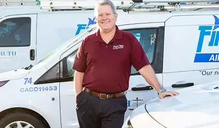 First Class vice president Brad Harmer beside a company van showing license CAC011453