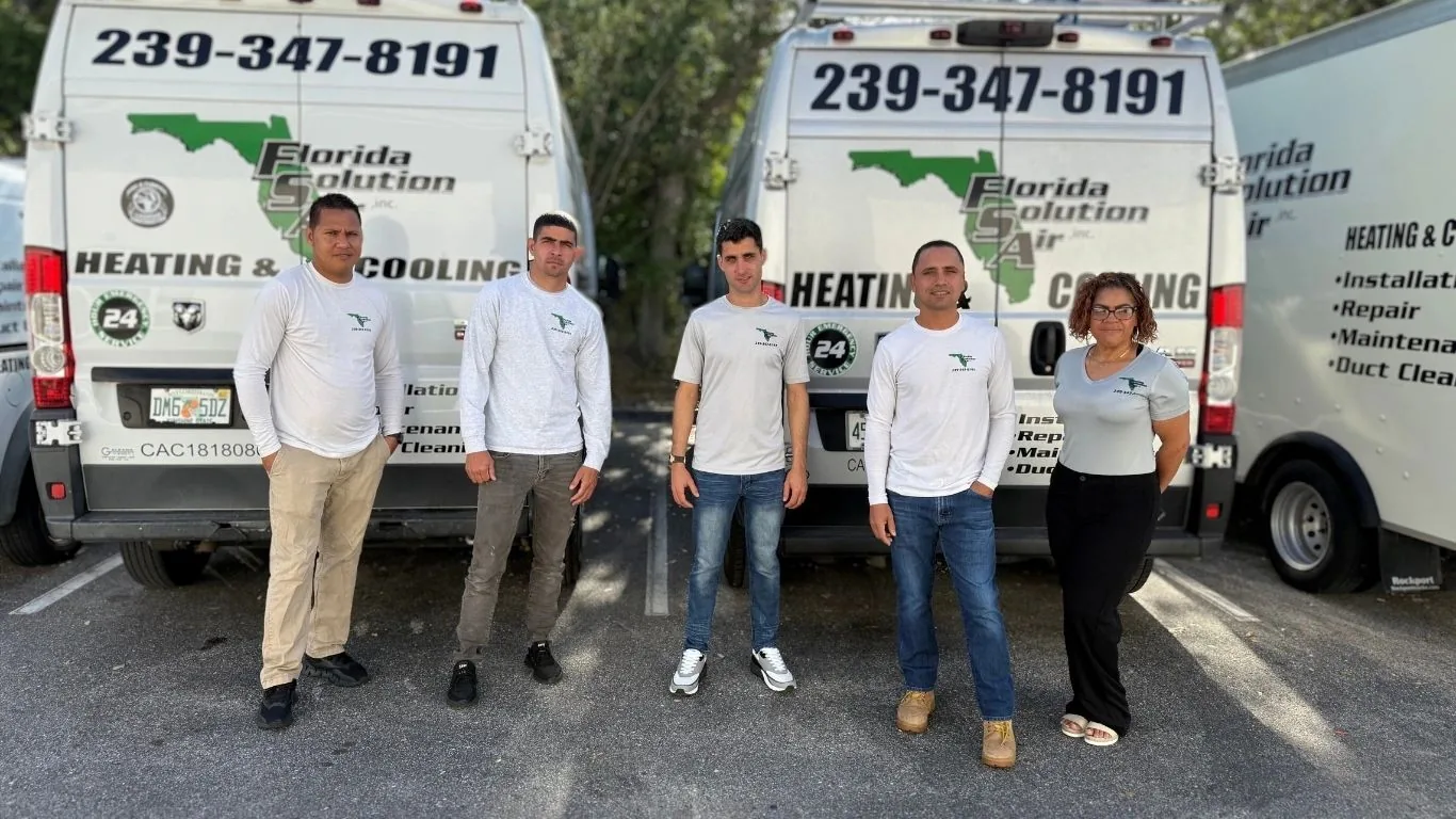 Florida Solution Air team in front of two company vans