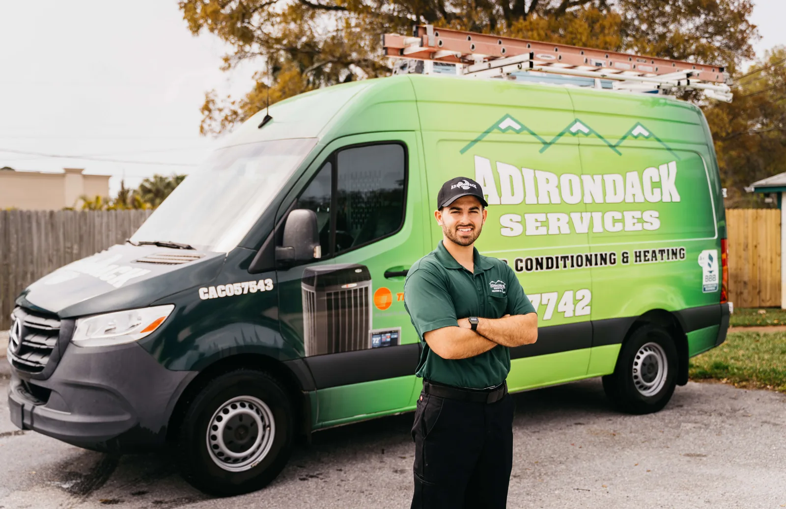 Adirondack Services technician with a lettered service van