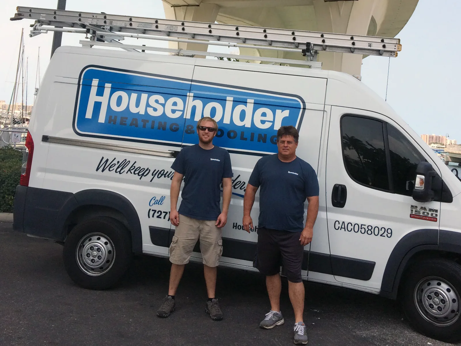 Two Householder technicians in front of a lettered service van