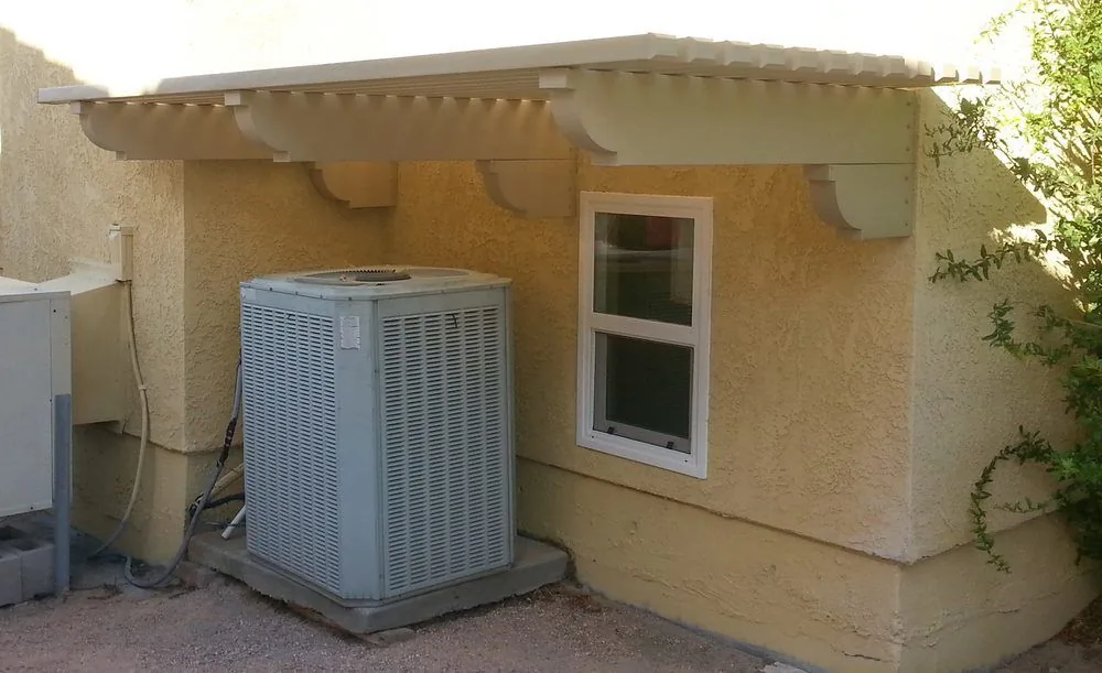 Newly installed outdoor AC unit beside a stucco building