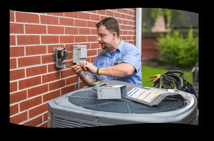 Easco technician in a company cap working at an outdoor condenser