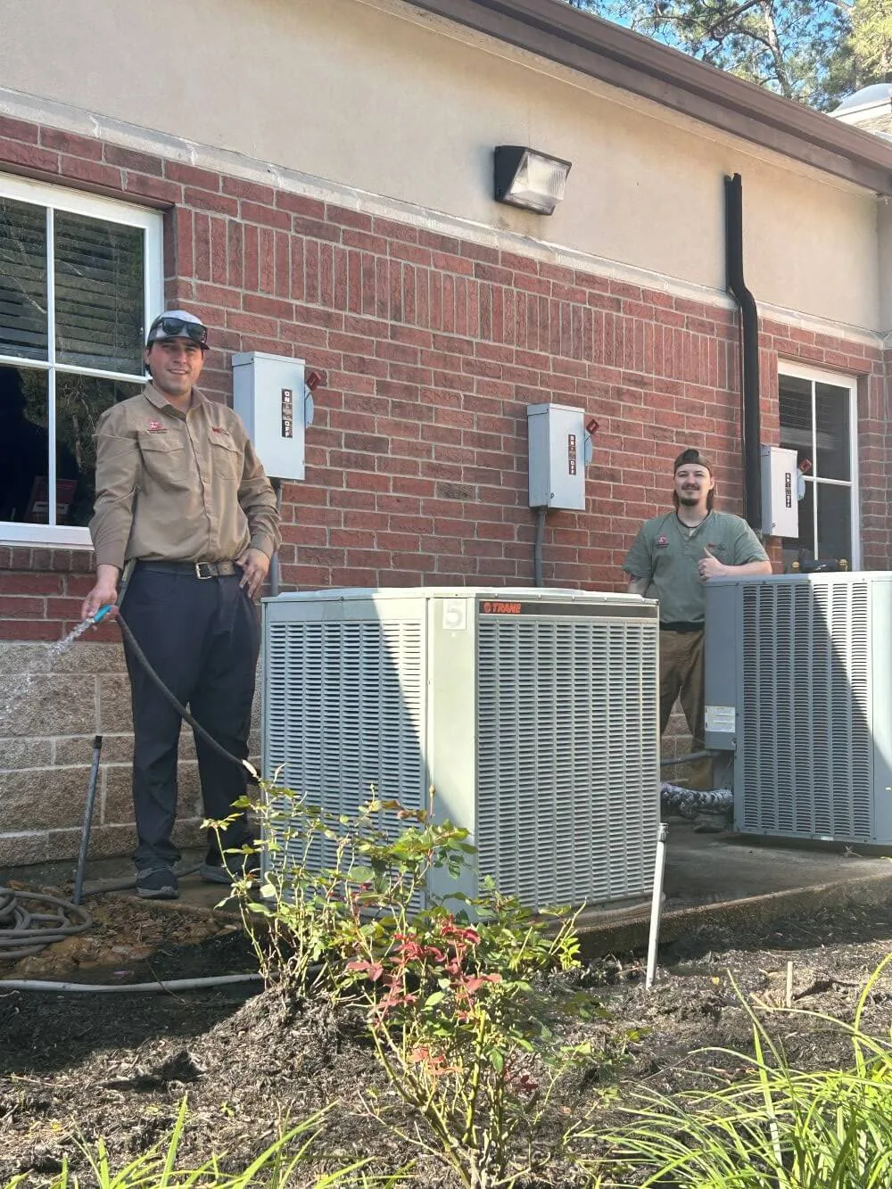 Jack Gordon & Sons crew installing condensing units outside a brick building