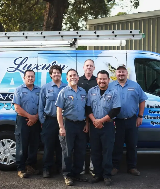 Luxury Air technicians in front of a company service van