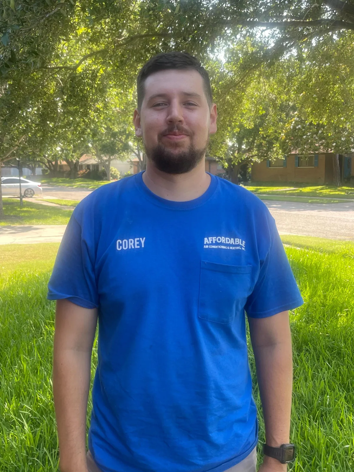 Affordable A/C & Heating installer and technician Corey in a company shirt