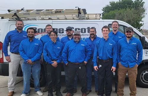 Bodine-Scott team in front of a company service van