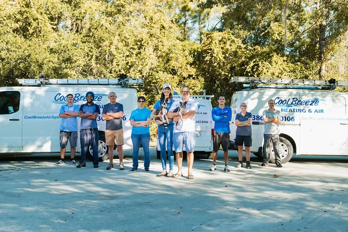 Cool Breeze Heat & Air team in front of two company vans