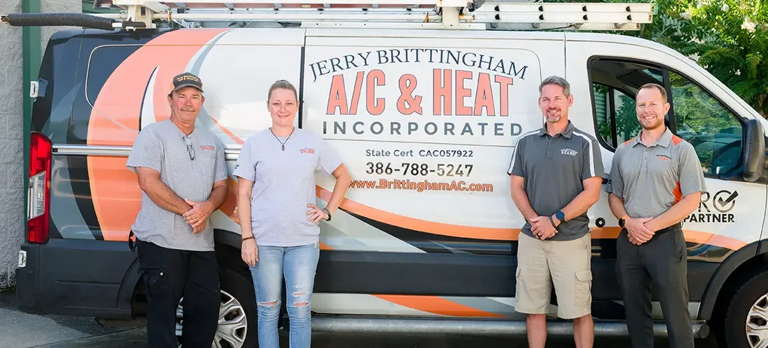 Jerry Brittingham A/C & Heat staff beside a company van