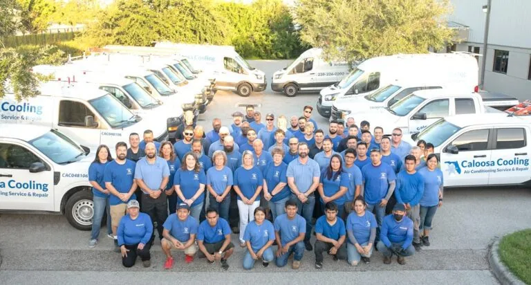 Caloosa Cooling staff in front of the company's service vans