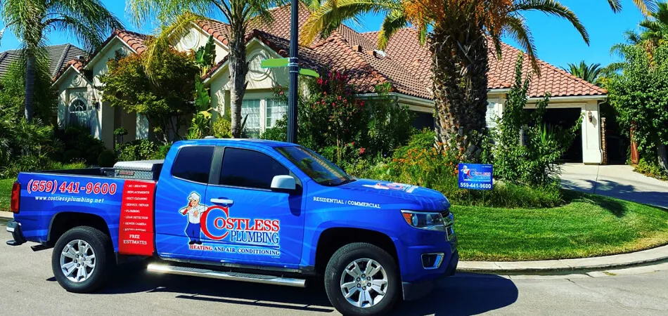 Costless Plumbing, Heating & Air pickup truck parked outside a house