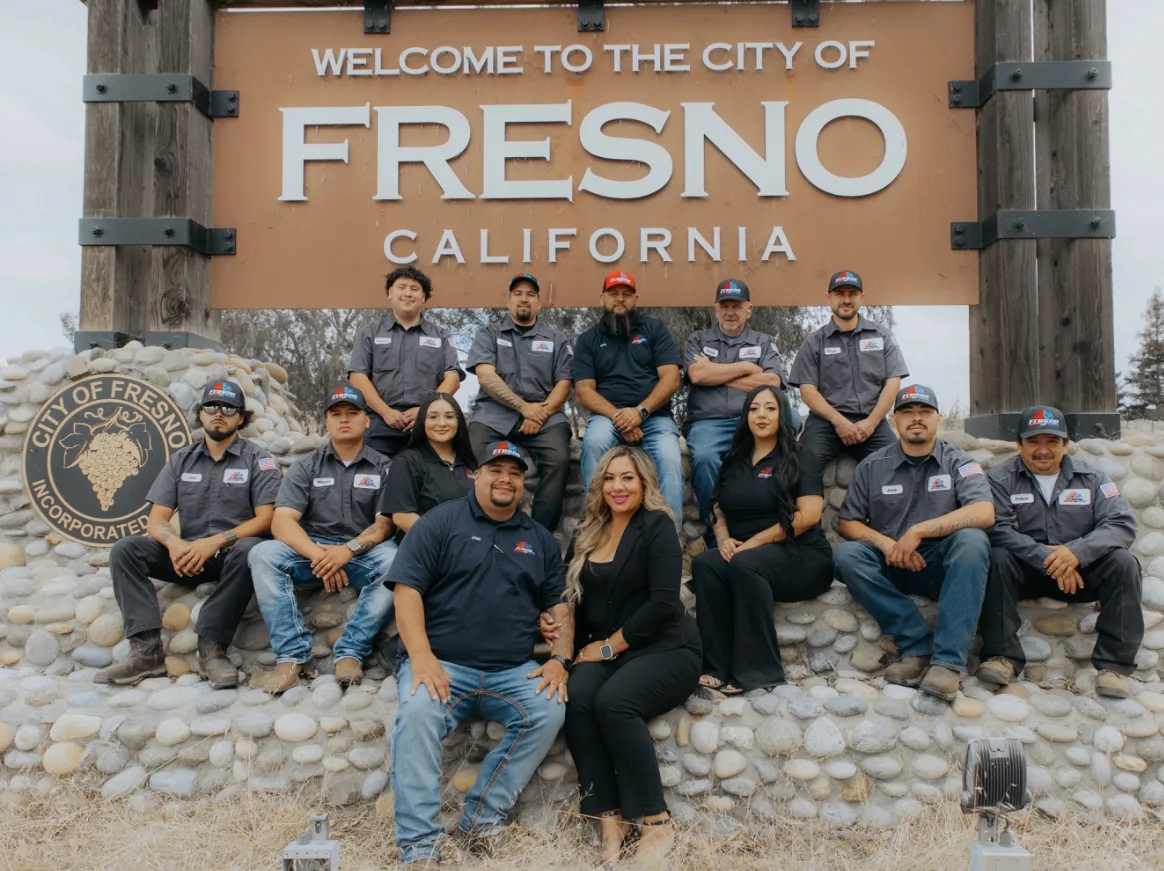 Fresno's Heating and Cooling crew at the Welcome to the City of Fresno sign