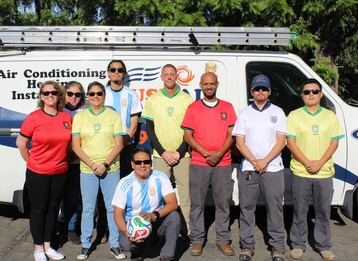 Just Air Heating & Cooling team in front of a company van