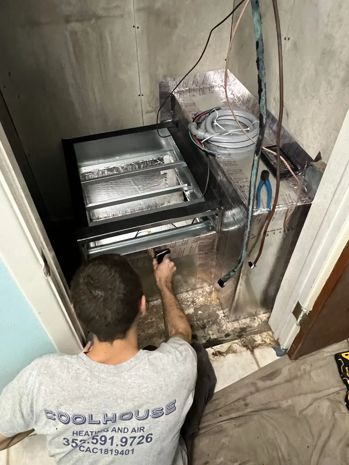Coolhouse technician working on an indoor air handler