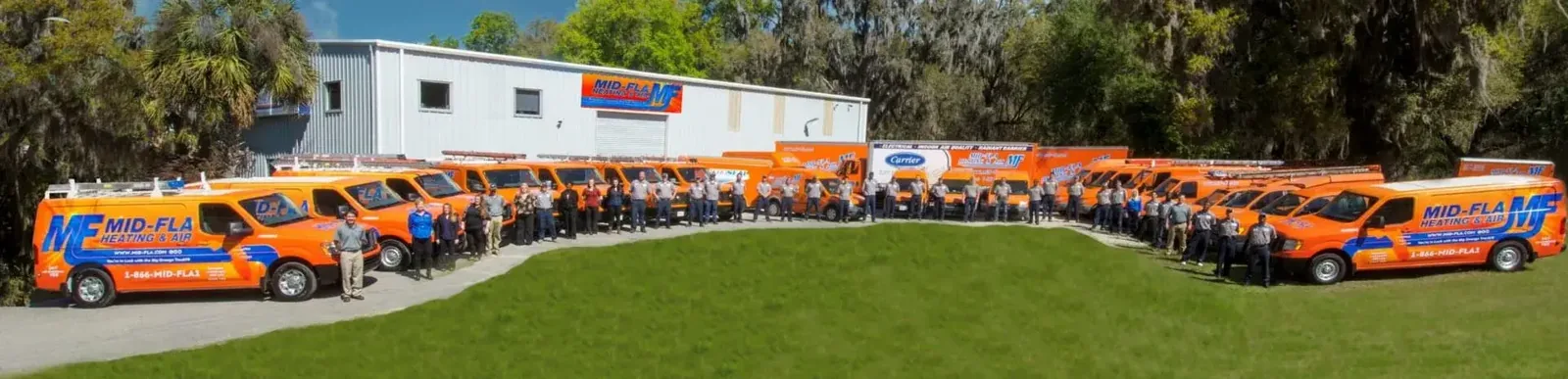 Mid-Florida Heating & Air staff and service vans lined up outside the office