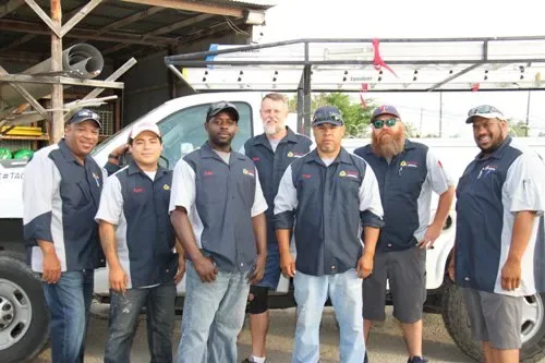 Artie’s Heating & Air Conditioning crew in front of a service truck