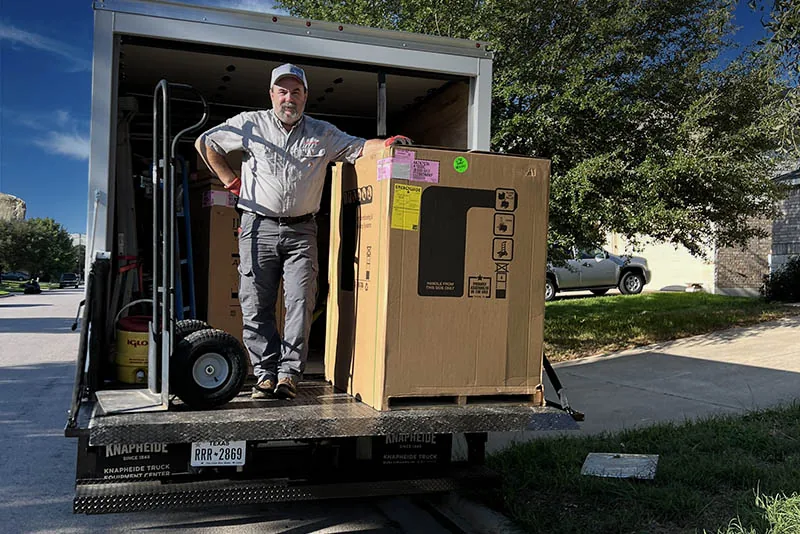 CTR Services team member delivering new HVAC equipment from the company box truck