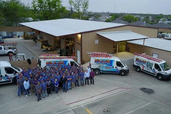 Ellis Air Systems staff and vans outside the company building, seen from a drone