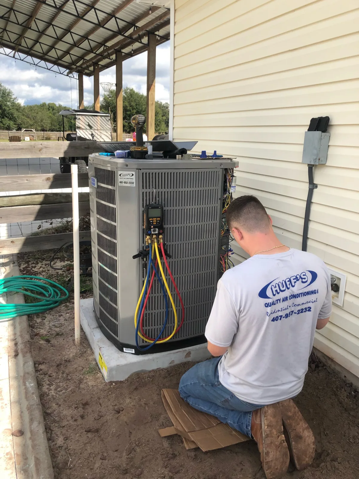 Huff's technician servicing an outdoor AC unit