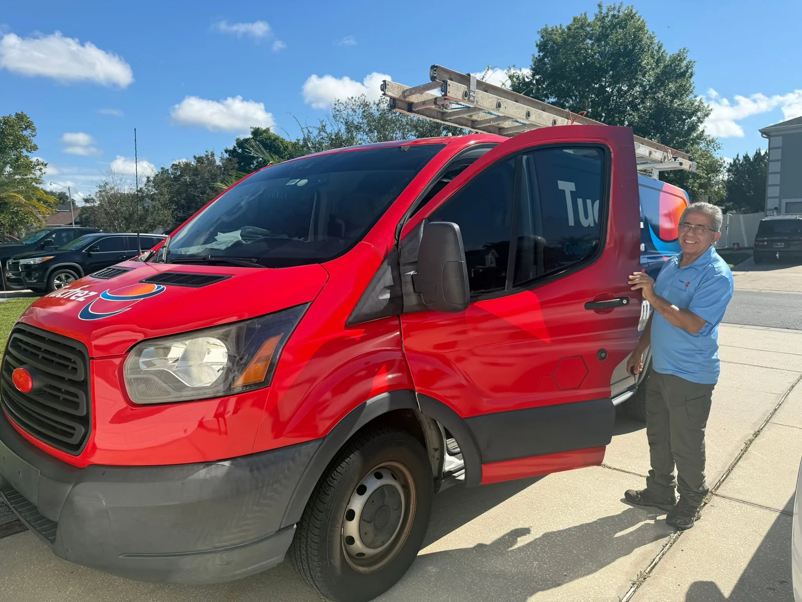 Tucfrez technician beside a company van