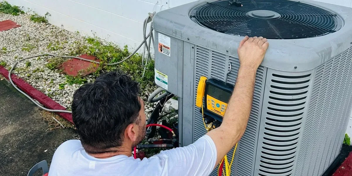 Central Air of Florida technician testing an outdoor AC unit