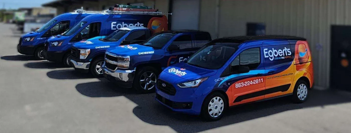 Egbert's Cooling & Heating branded vans and trucks parked in a row