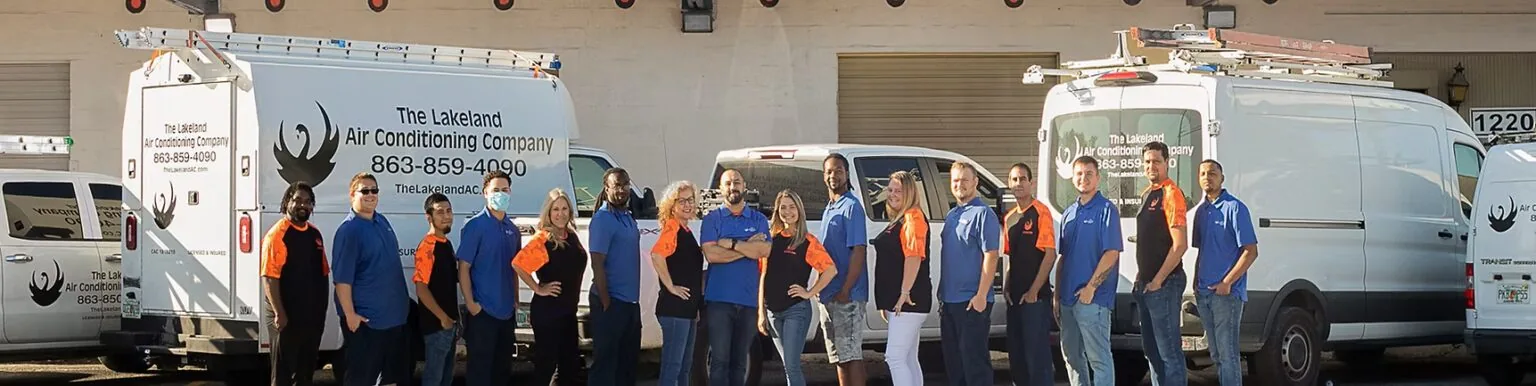 Lakeland Air Conditioning Company team in front of its service vans
