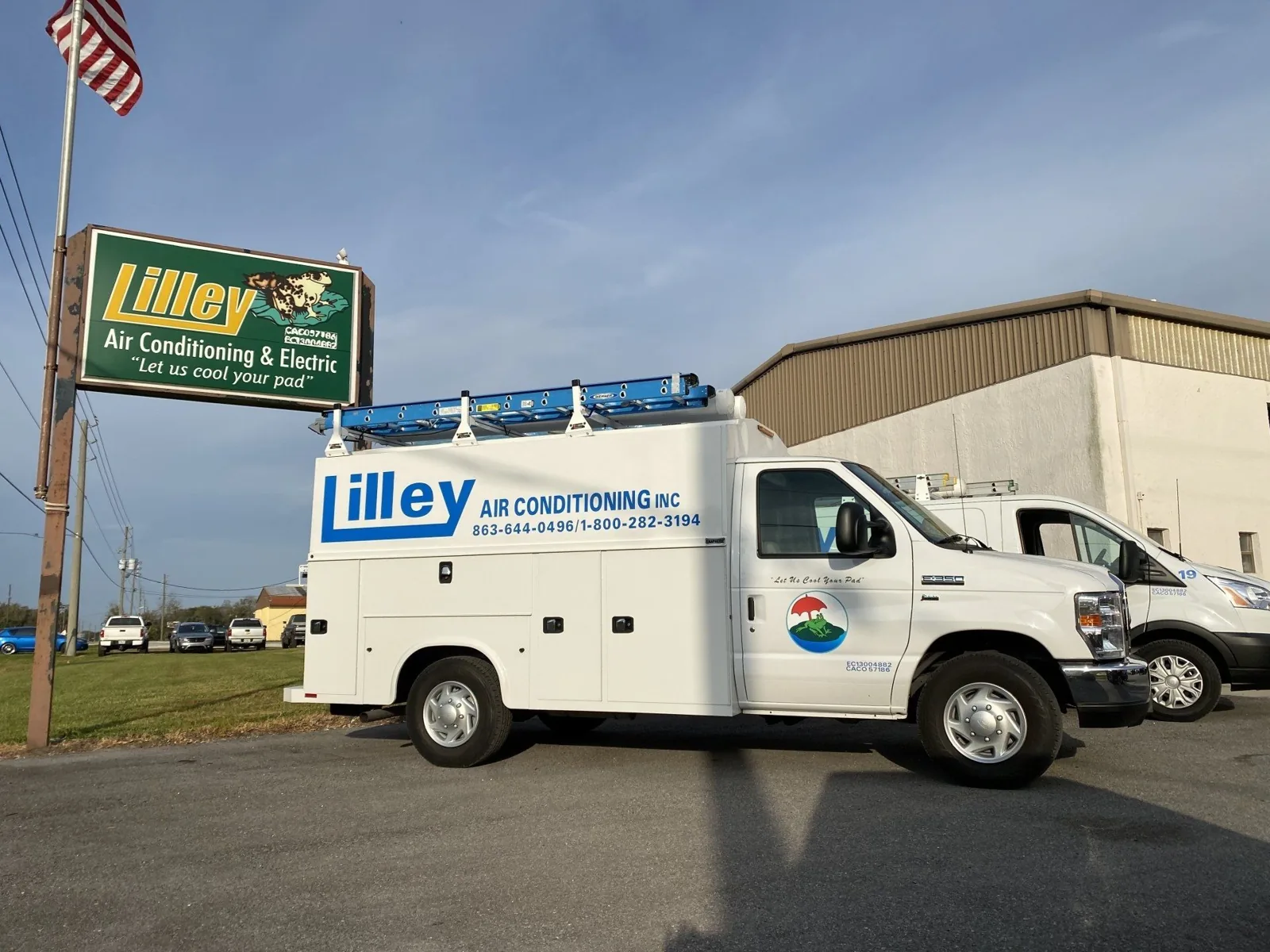Lilley Air Conditioning service trucks parked outside the company office sign