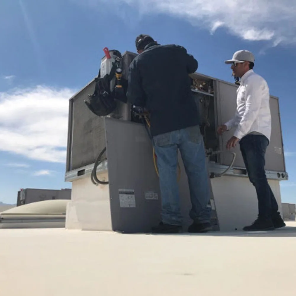 AC Captain technicians working on a rooftop package unit