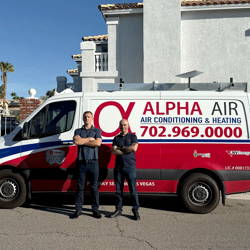 Two Alpha Air technicians in front of a company van