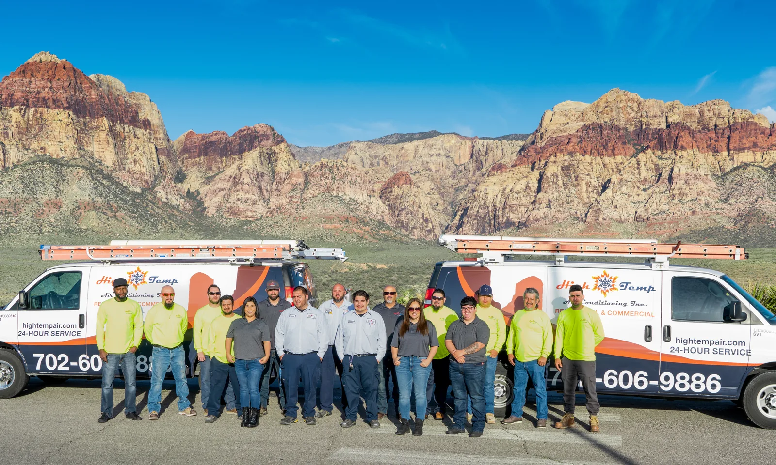 High Temp Air Conditioning team with two company vans in front of desert mountains