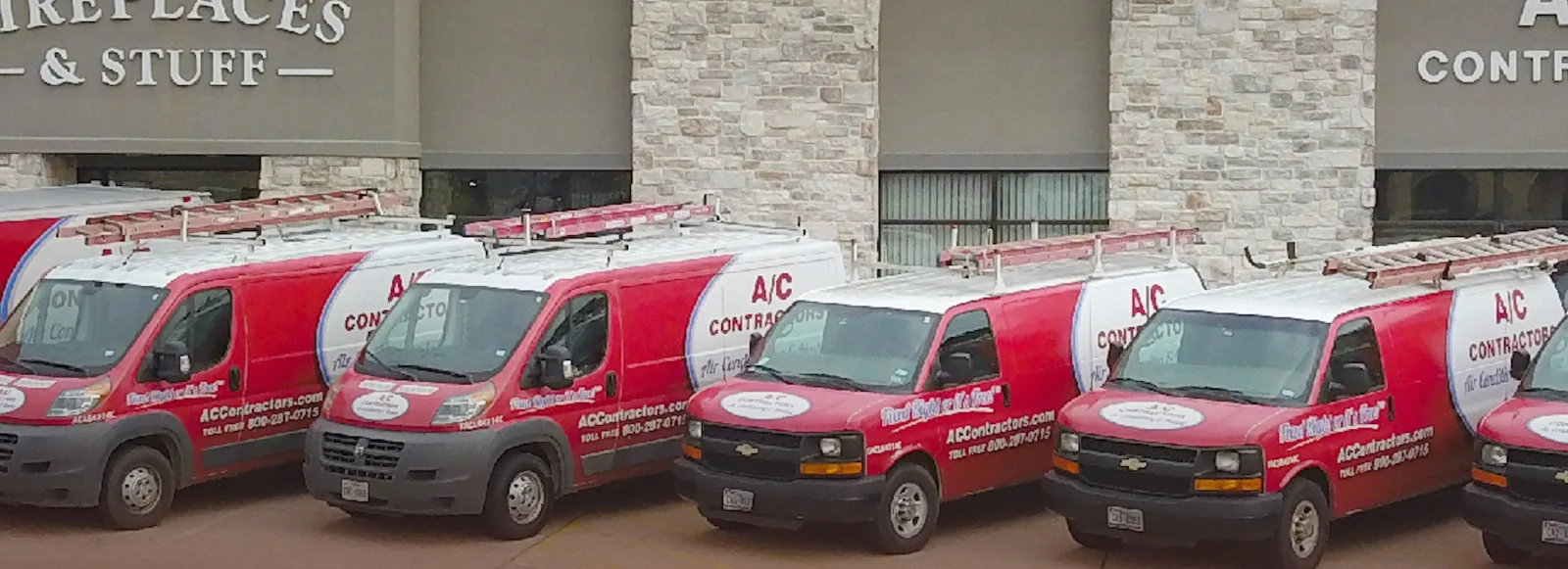 Row of red and white A/C Contractors service vans outside the Longview office