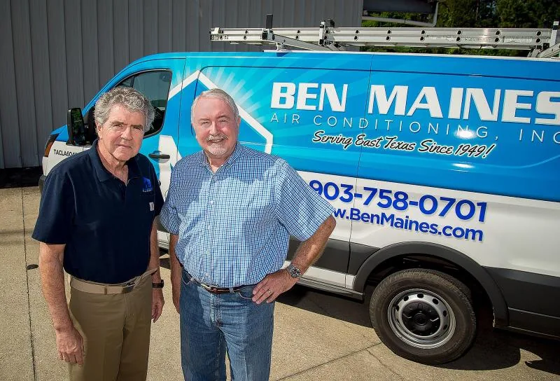 Two Ben Maines staff beside a branded Ben Maines service van