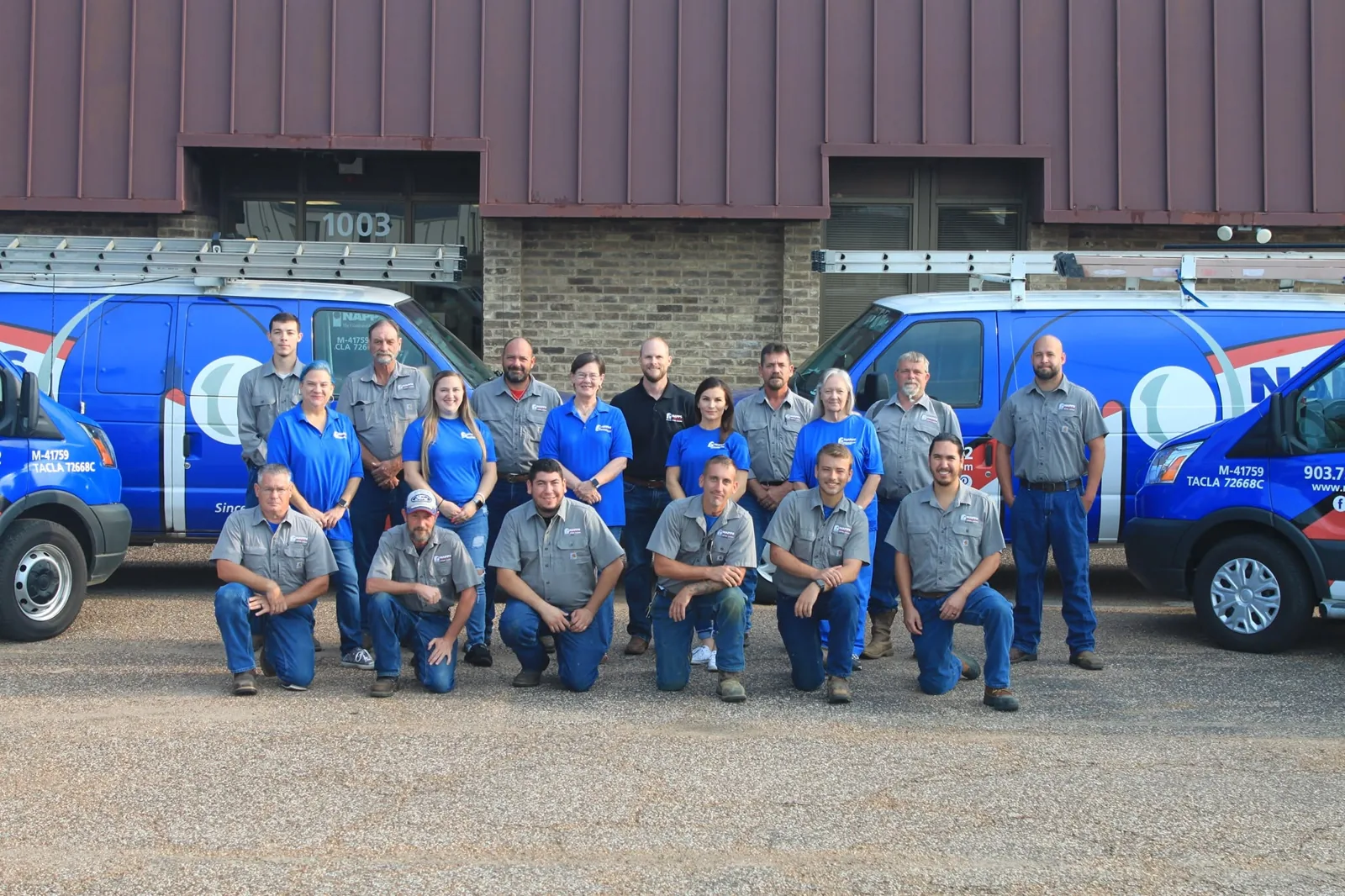 Napps staff lined up in front of the 1003 W Cotton St office and branded vans