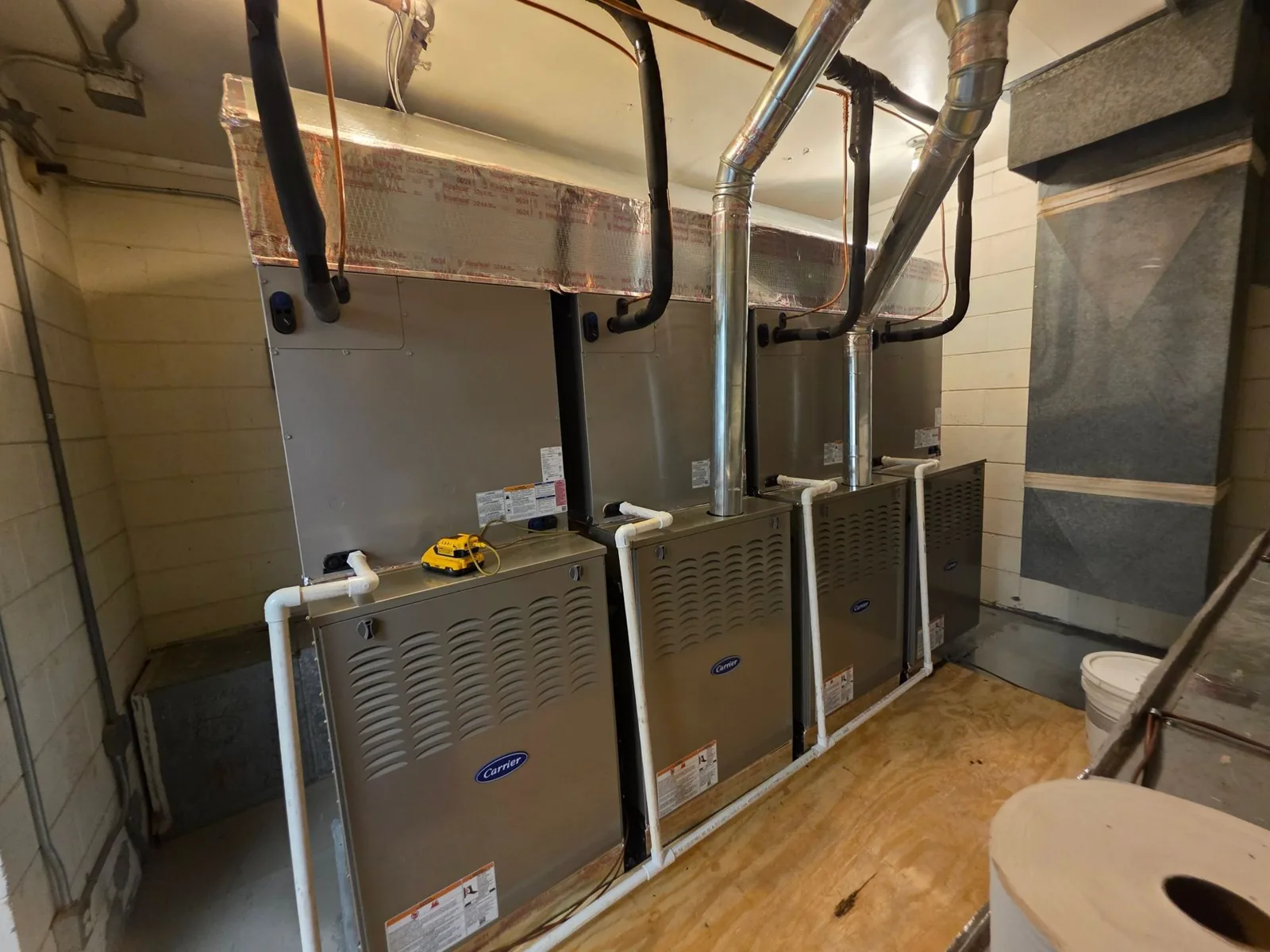Row of new furnaces installed by Duncan Heating & Air Conditioning