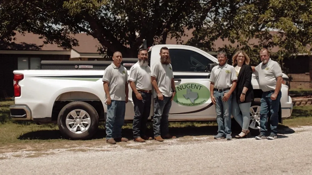 Nugent Mechanical Contractors team beside a company truck