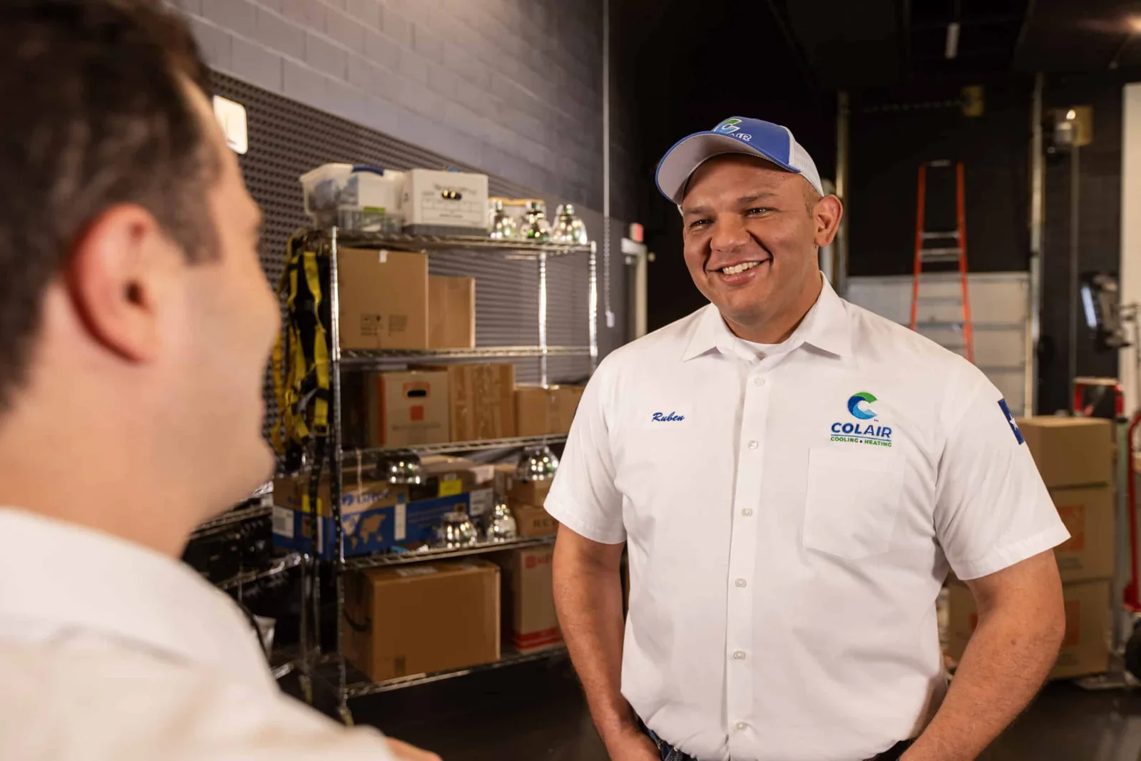 Colair technician in a company uniform in the parts room