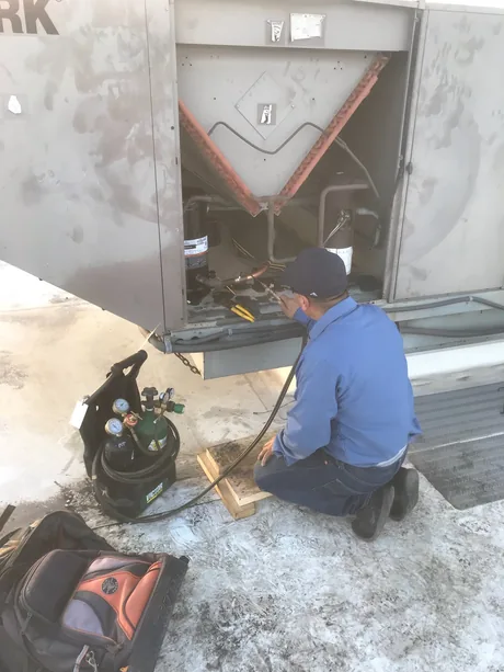 Freedom Air technician working at an outdoor unit