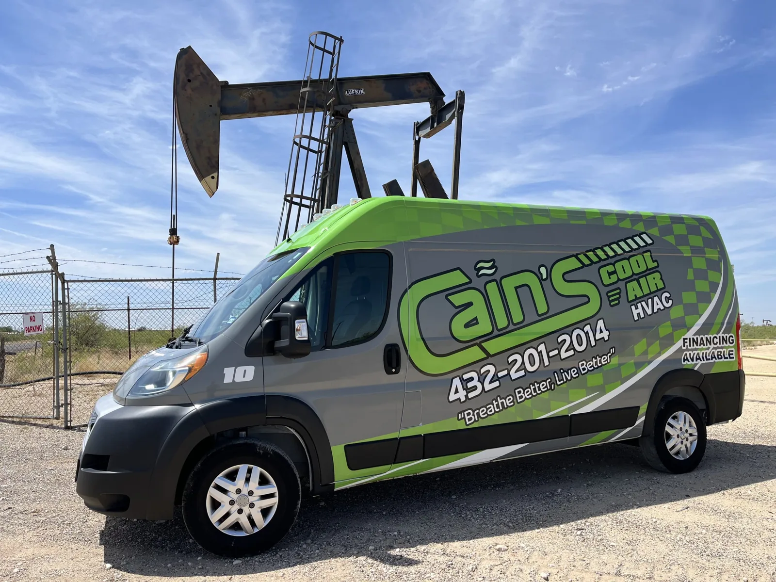 Cain's Cool Air service van parked by an oil pumpjack