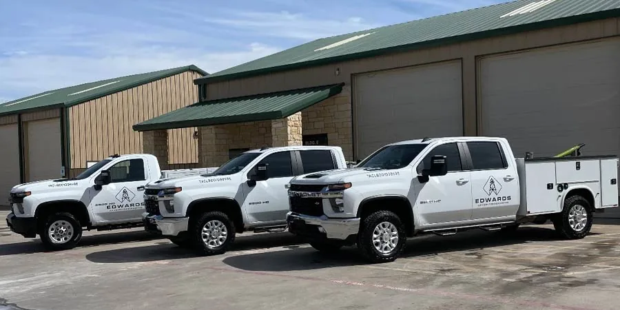 Three Edwards service trucks outside a commercial building