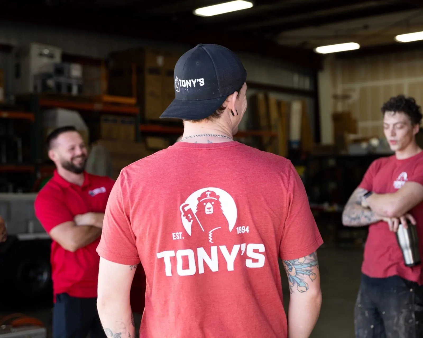 Tony's Plumbing, Heating & Air team members in company shirts at the shop