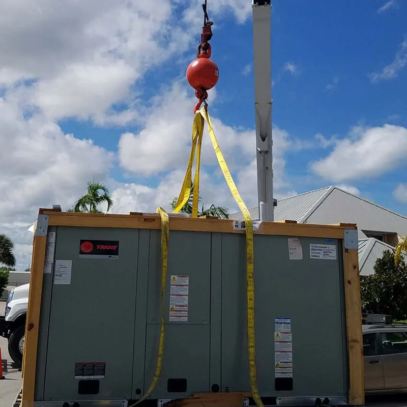 New packaged rooftop unit being lifted by crane on a Key to Cool job