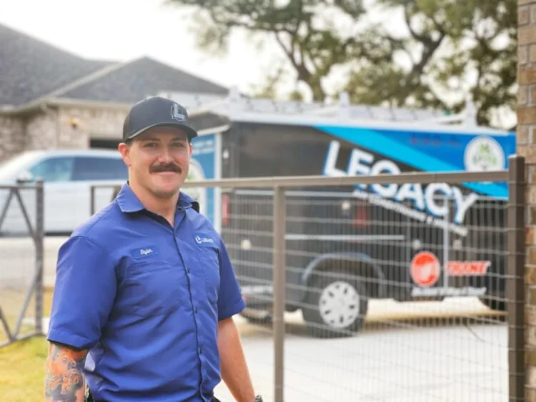 Legacy technician in front of a Legacy service van